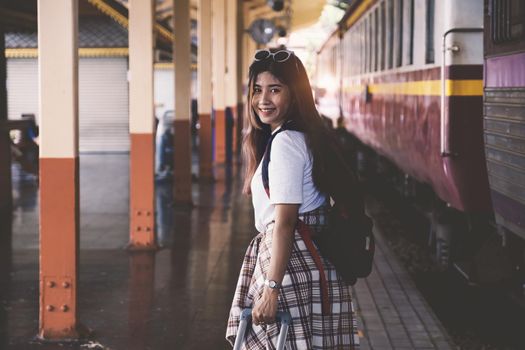 Alone traveler tourist walking with backpack at train station. work and travel lifestyle concept