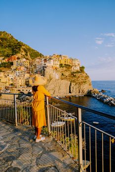 Colors of Italy Manarola village, Italy colorful coast Manarola Cinque Terre Italy, young Asian woman on vacation in Italy