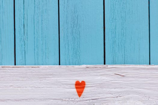Orange heart painted on Distressed Vintage Boy Blue Grunge Wood Grain Texture Background. blue textured wooden wall. shabby wood