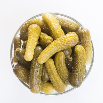 Small cucumbers in a transparent bowl, top view