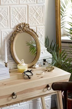 arrangement with mirror and perfume on wooden table