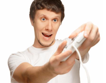 Young happy man is playing and holding a game joystick