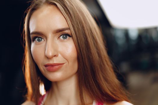 Young beautiful woman in sportswear in a gym close up