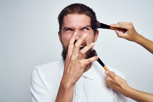 bearded man in white shirt cosmetics makeup. High quality photo