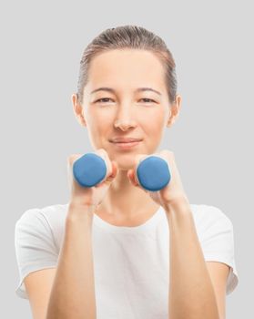 Young woman with dumbbells, concept of healthy life