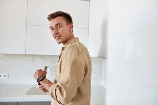 Happy smiling caucasian man in new fresh light apartments