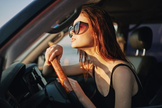 pretty woman in sunglasses driving a car trip. High quality photo
