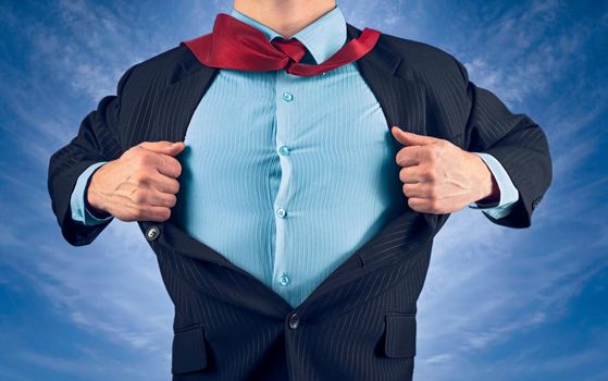 Businessman opens jacket showing his shirt on background of sky, face is not visible