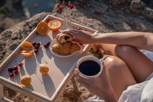 Mediterranean breakfast, cup of coffee and fresh bread on a table with beautiful sea view at the background.
