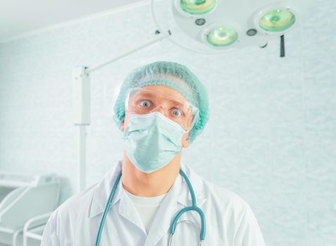 Portrait of man crazy doctor surgeon in a hospital