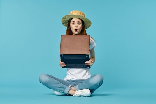 woman with laptop learning internet online education blue background. High quality photo