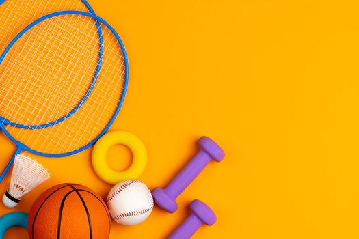 Assortment of sport equipment on yellow background, top view. High quality photo
