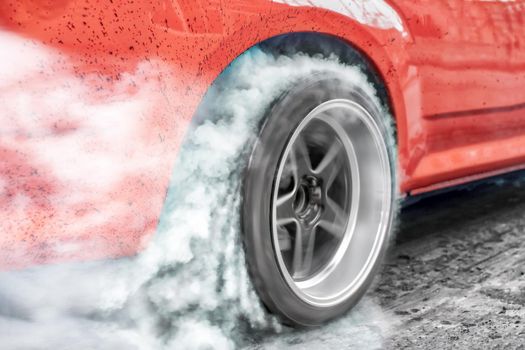 Drag racing car burns rubber off its tires in preparation for the race