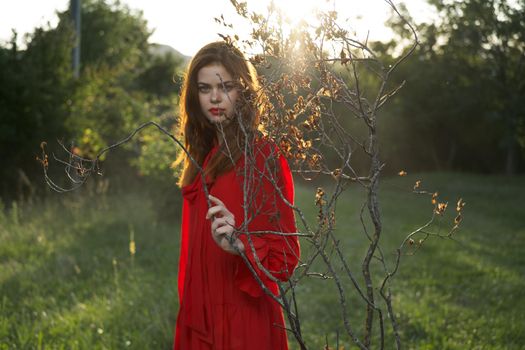 attractive woman in red dress outdoors fresh air summer. High quality photo