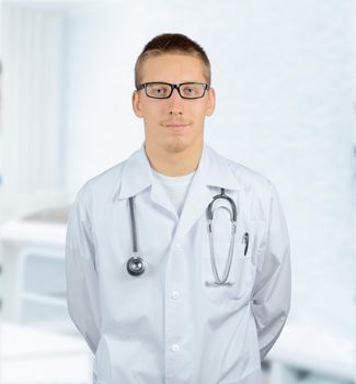 Practitioner man doctor smiles in a hospital