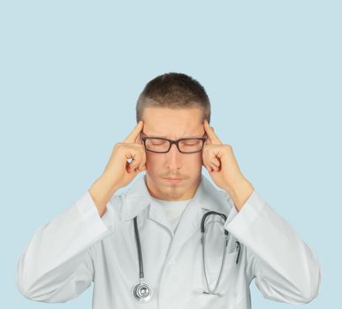 Man doctor with migraine headache overworked, doctor touches his head