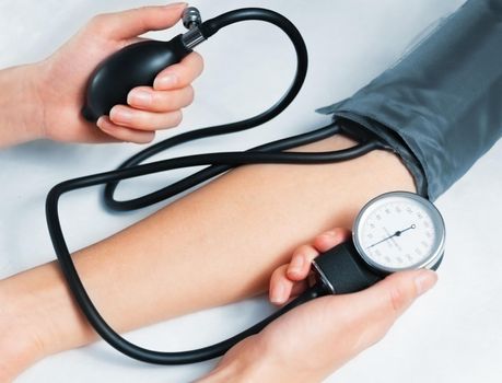 Doctor measures blood pressure a patient, top view