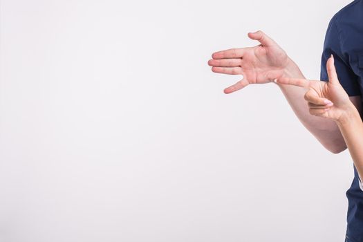 Couple pointing at the left corner with fingers standing isolated over white background. Copy space for product advertisement