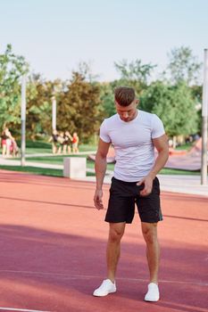 athletic men doing exercises on the sports ground in summer. High quality photo