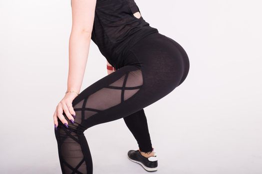 Close-up of girl dancing twerk in the dance class on white background.