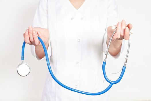 doctor gives the woman in the hands of a stethoscope