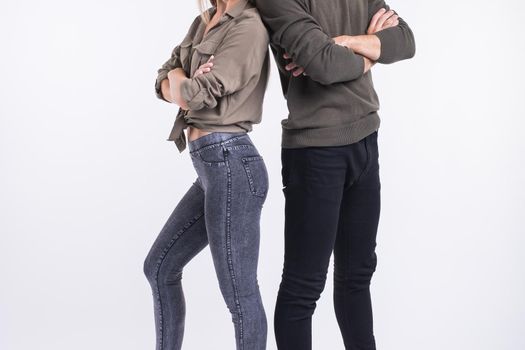 Close-up of couple woman and man standing back to back. They look very sad, disappointed with each other, isolated on white background. Marriage, relationship problems. Human emotions, expressions.