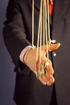Businessman gives a handshake, hand on the ropes, concept of managing people