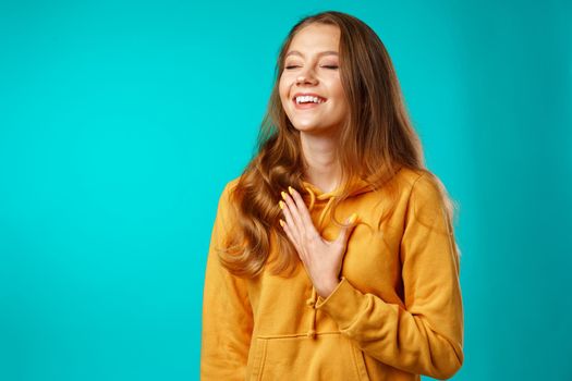 Young attractive cheerful girl laughing with joy close up
