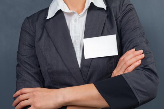 Unrecognizable businesswoman with id card on the chest, copyspace
