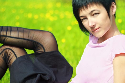 funny woman is lying on the grass