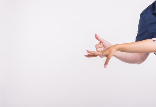 Couple pointing at the left corner with fingers standing isolated over white background. Copy space for product advertisement