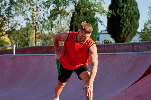 athletic man on the sports ground rubber band exercise. High quality photo