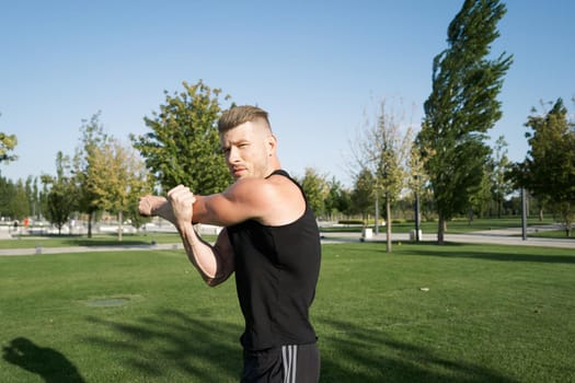 beefy man and athlete in the park during summer workout. High quality photo