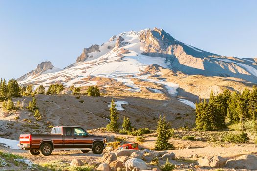 The Top of Mt. Hood, Oregon, and a red pickup truck on the foreground