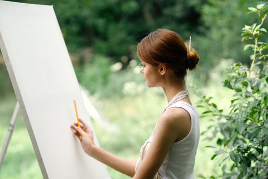 woman artist nature easel drawing creative landscape. High quality photo