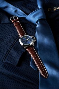 luxury fashion watch with blue dial and brown crocodile grain leather watch band