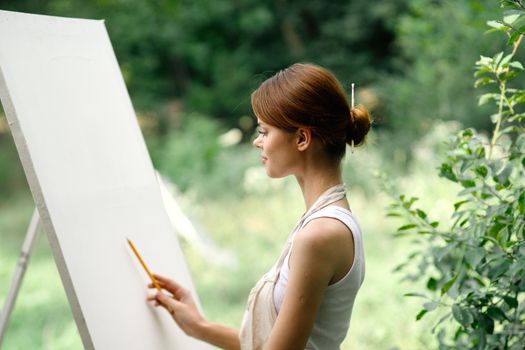 woman artist nature easel drawing creative landscape. High quality photo