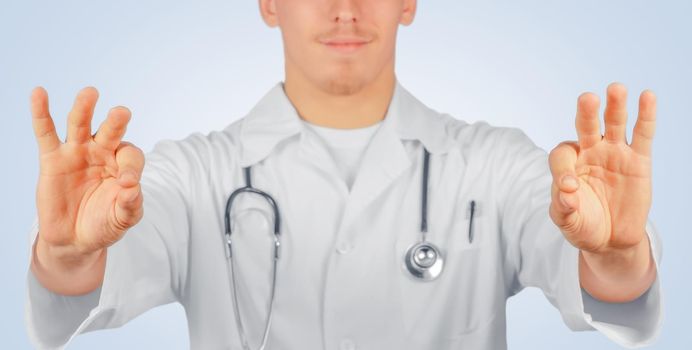 Man doctor holds something in the air, space for text