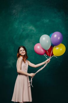 cheerful woman with colorful balloons birthday fun. High quality photo