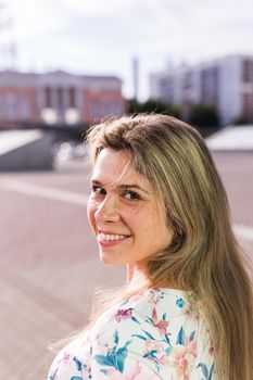 Portrait of happy cheerful smiling young beautiful blond woman outdoor. Summer and people.