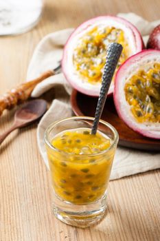 Fresh passion fruit on wooden background. Passion fruit contains many small black seeds covered with the fruit's flesh.