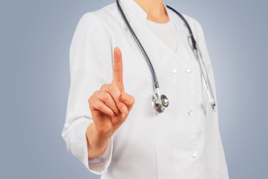Unrecognizable female doctor is touching something in the air, copyspace