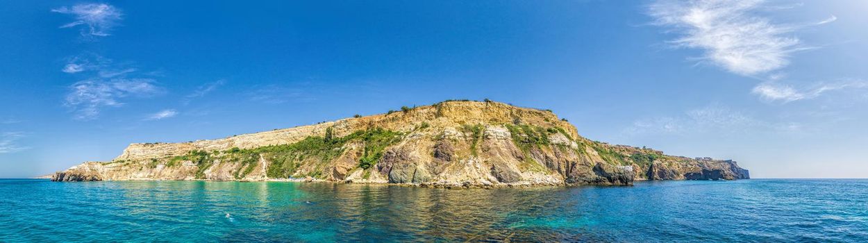 Yachts in the Sea on a background of rocky shores. Sea landscape with yachts and rocky coastline. Copy space. The concept of an travel, relax, active and healthy life in harmony with nature