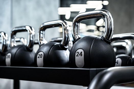Close up photo of new dumbbells on a rack in a gym