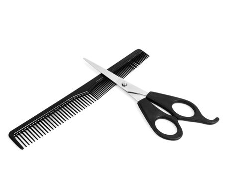 Comb and scissors on white background