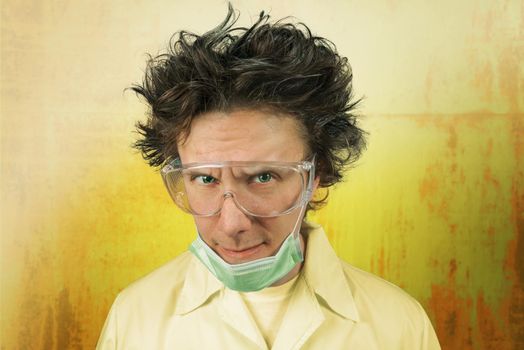 Portrait of a male mad scientist on the background of rusty metal