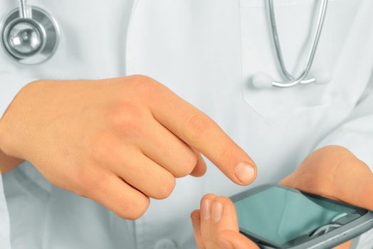 Unrecognizable doctor is touching on mobile phone, close-up
