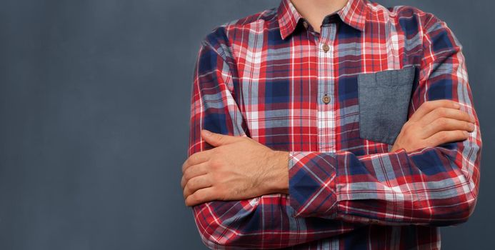 Unrecognizable man in shirt standing near the blackboard, space for text