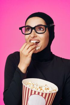 Muslim woman fun popcorn entertainment fashion isolated background. High quality photo