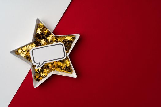Star shaped plate with golden confetti top view copy space